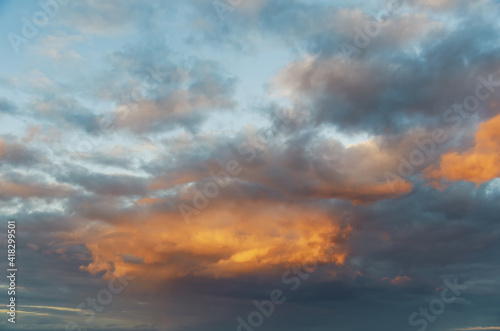 Stunning sunset with orange and blue clouds in dramatic sky