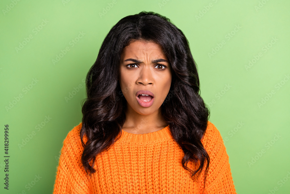 Fototapeta premium Photo of shocked impressed dark skin woman wear orange sweater open mouth isolated green color background