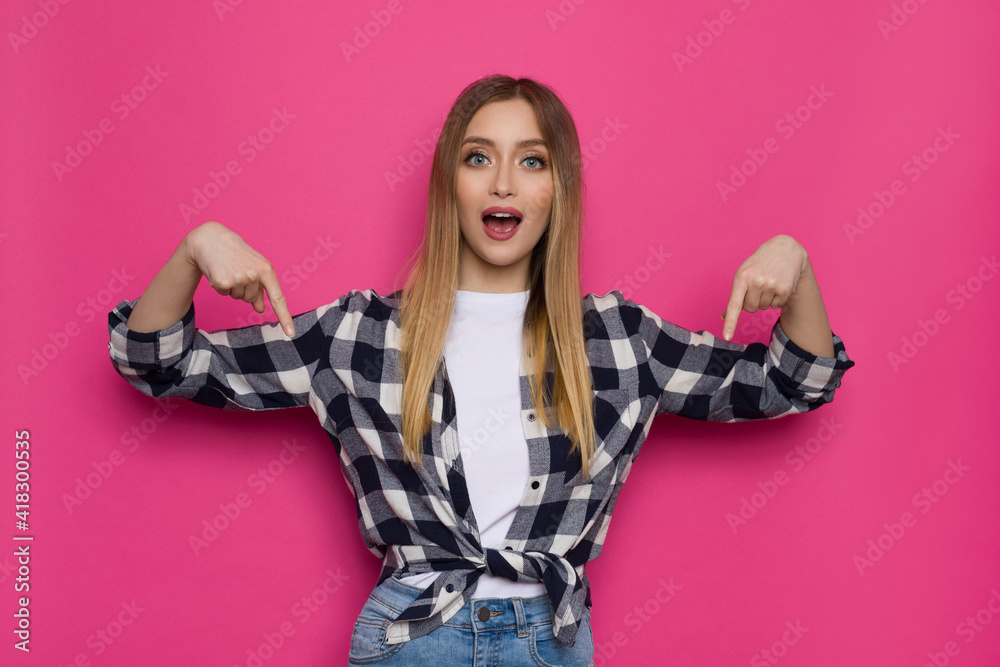 Casual Young Woman Is Pointing Down And Talking. Casual Young Woman Is Pointing Down And Talking.