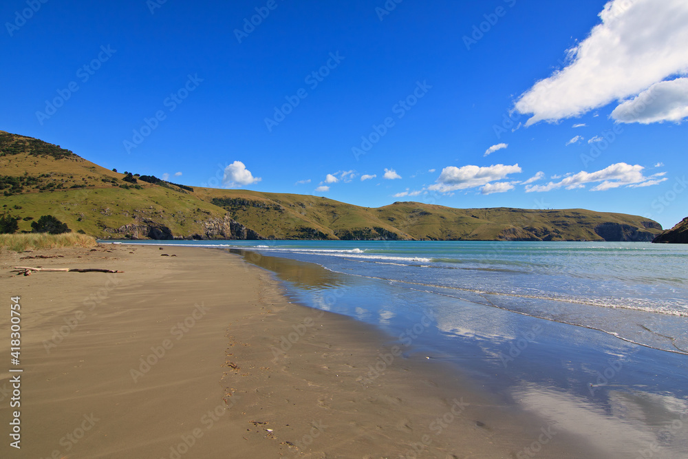 Idyllic sand beach on Akaroa peninsula in New Zealand Idyllic sand beach on Akaroa peninsula in New Zealand