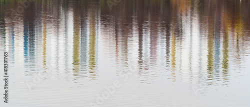 Multicolored reflections of city buildings in lake