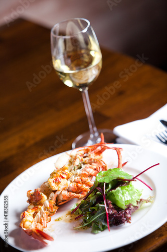 Grilled shrimps and white wine in restaurant