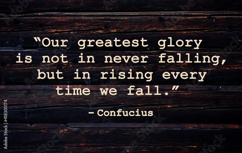 “Our greatest glory is not in never falling, but in rising every time we fall.”  Inspirational quote on vintage retro background. Ancient Chinese philosopher Confucius quote.