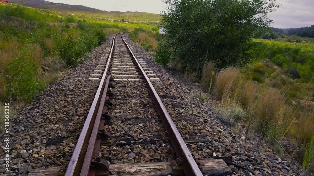Aerial of railroad track in an empty valley Aerial of railroad track in an empty valley