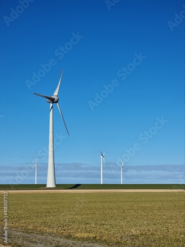 Windmill village indrustial wind mill by the lake Ijsselmeer Nehterlands. renewable energy green energy photo