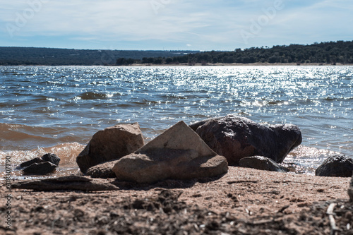 Closeup of stones near water Las Cogotas Reservoir, Mingorria, Avila, Castilla-Leon, Spain