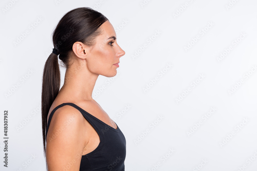 Profile side photo of young beautiful charming serious sporty woman look copyspace isolated on white color background Profile side photo of young beautiful charming serious sporty woman look copyspace isolated on white color background
