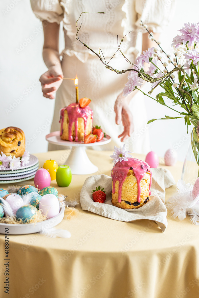 Easter table setting. Easter cake craffin. Woman on background Easter table setting. Easter cake craffin. Woman on background