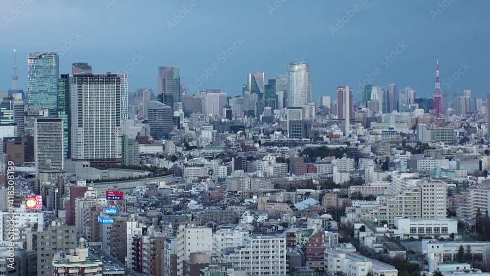 TOKYO, JAPAN : Aerial high angle sunset CITYSCAPE of TOKYO. View of buildings and streets at central downtown area. Japanese city life and metropolis concept. Time lapse tracking shot dusk to night. TOKYO, JAPAN : Aerial high angle sunset CITYSCAPE of TOKYO. View of buildings and streets at central downtown area. Japanese city life and metropolis concept. Time lapse tracking shot dusk to night.