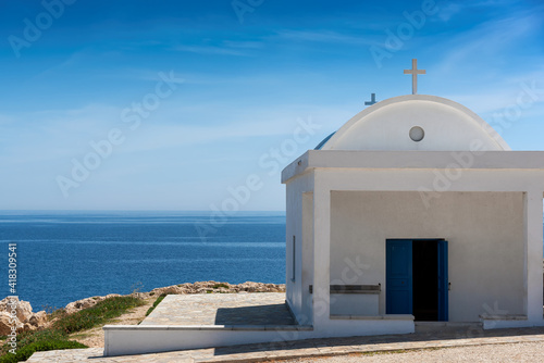 White and blue chapel by the sea in Cyprus, Mediterranean sea coast. 