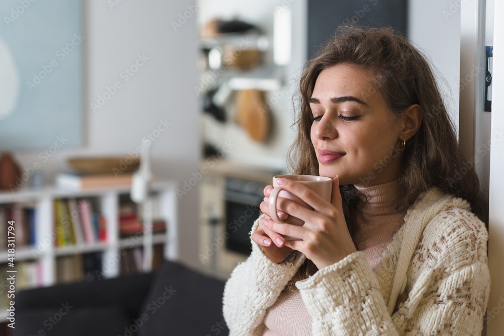 portrait of woman in her apartment. she drinking coffee portrait of woman in her apartment. she drinking coffee