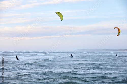 people kite surfing on the water in the ocean