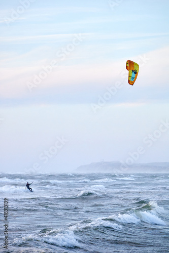 kite surfing on the water with yellow kite