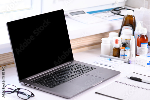 . Online service, sale of medicines. On the table there is a computer and many medical supplies. Online learning