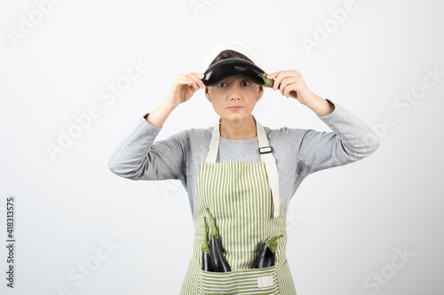 Image of beautiful housewife having eggplants in apron and showing one © azerbaijan-stockers