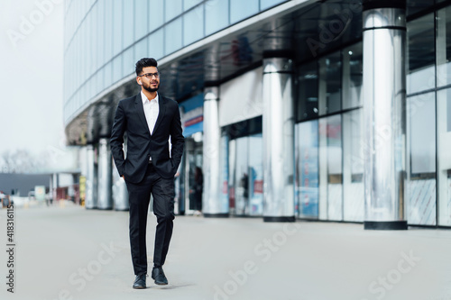 Modern handsome indian man businessman going to work, modern office, modern indian man