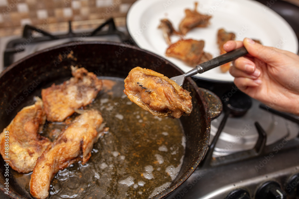 The fish is fried in oil The fish is fried in oil