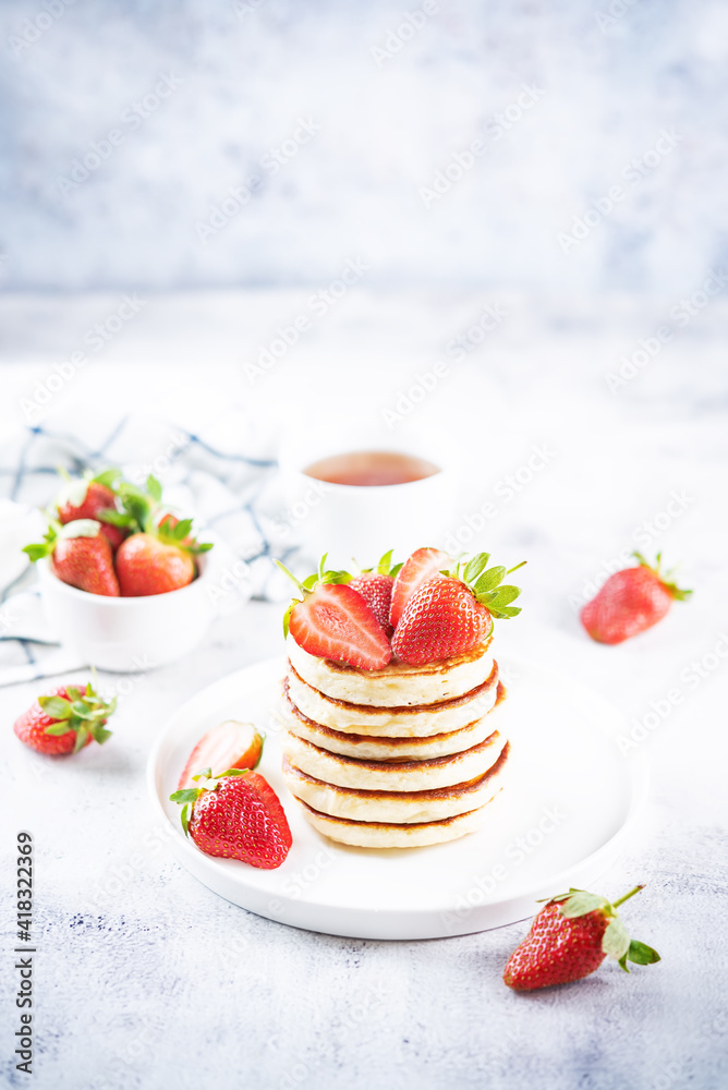 Pancakes decorated with strawberries in a plate Pancakes decorated with strawberries in a plate