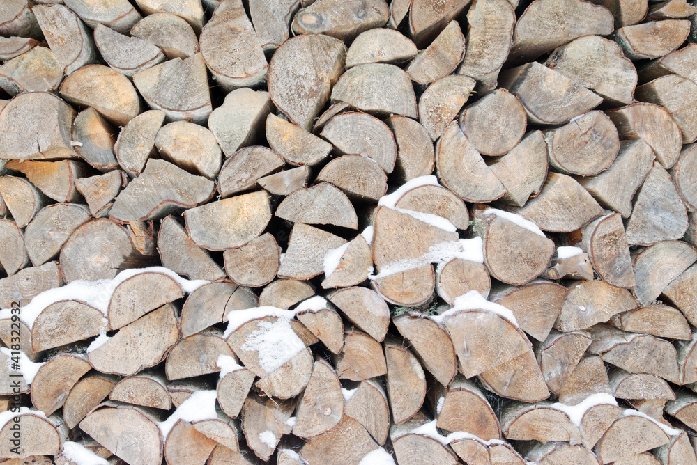 Pile of chopped firewood for winter covered with snow Pile of chopped firewood for winter covered with snow