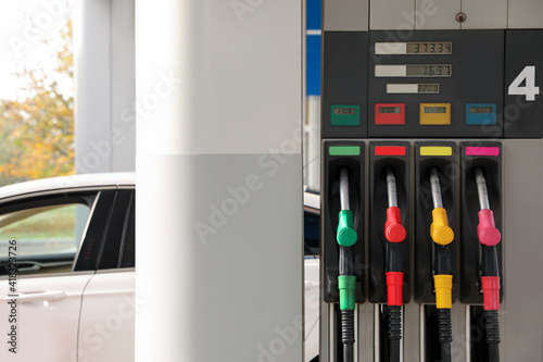 Petrol pump filling nozzles at gas station