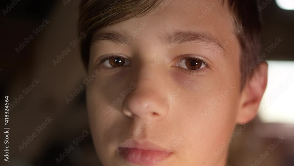 portrait of a sad serious boy looking at the camera, indoors, eyes close-up portrait of a sad serious boy looking at the camera, indoors, eyes close-up