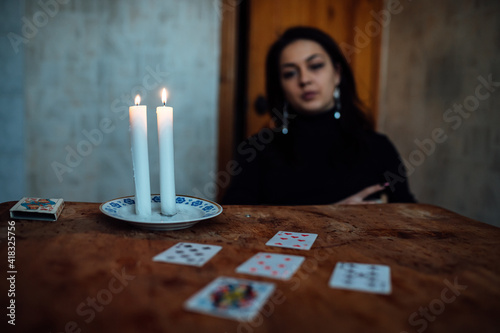 choose a card from the hands of a fortune teller. a woman tells fortunes during a magical ritual. belief in mysticism