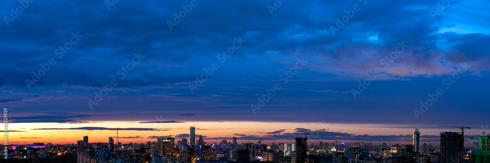 Dawn clouds over the metropolis of early winter sunset