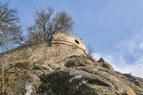 view of the ruins of an ancient fortress on a rocky hilltop photo