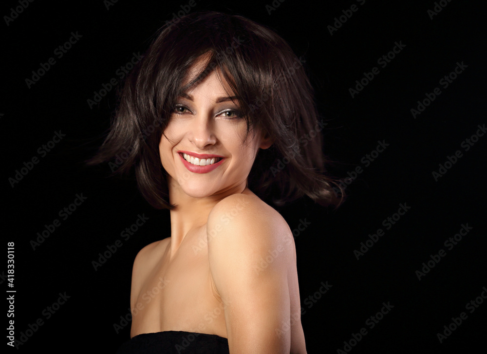 Happy laughing bright makeup woman shaking her black short hair on black background. Closeup portrait Happy laughing bright makeup woman shaking her black short hair on black background. Closeup portrait