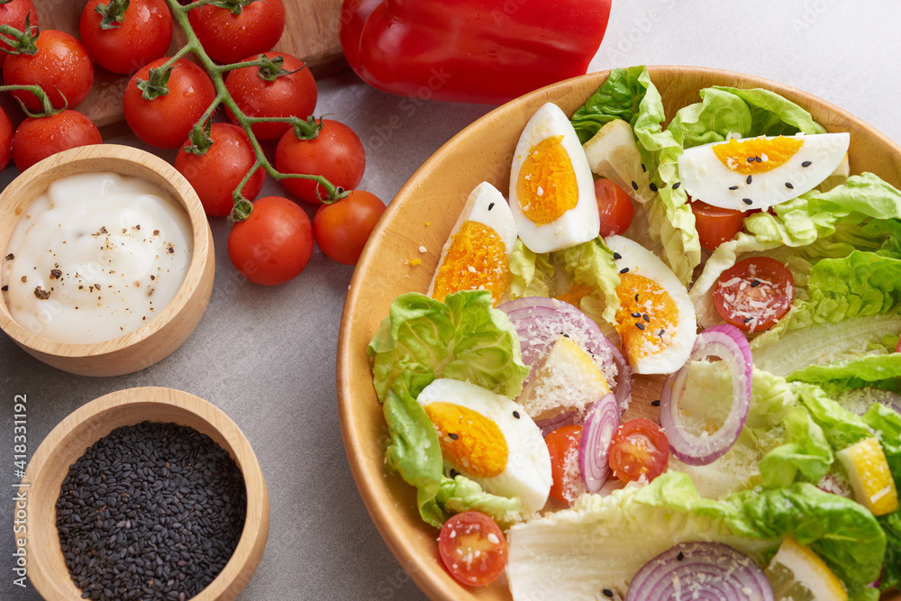 Diet menu. Healthy salad of fresh vegetables - tomatoes, egg, Onion. high angle view of a nutritious vegetable salad with boiled egg slices, served. Healthy meal concept. Diet menu. Healthy salad of fresh vegetables - tomatoes, egg, Onion. high angle view of a nutritious vegetable salad with boiled egg slices, served. Healthy meal concept.