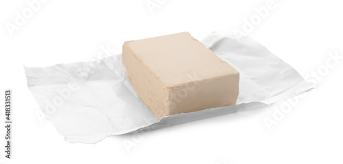 Unwrapped block of compressed yeast on white background