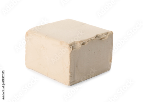 Block of compressed yeast on white background