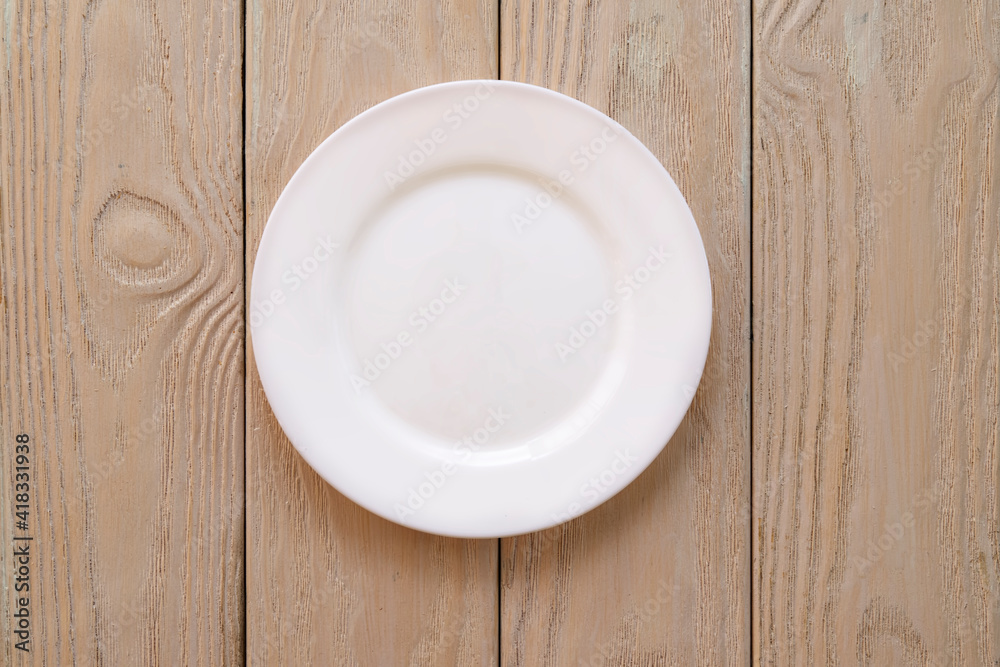 An empty white plate on light wooden planks,
Natural wood , blank space for text, copy space An empty white plate on light wooden planks,
Natural wood , blank space for text, copy space