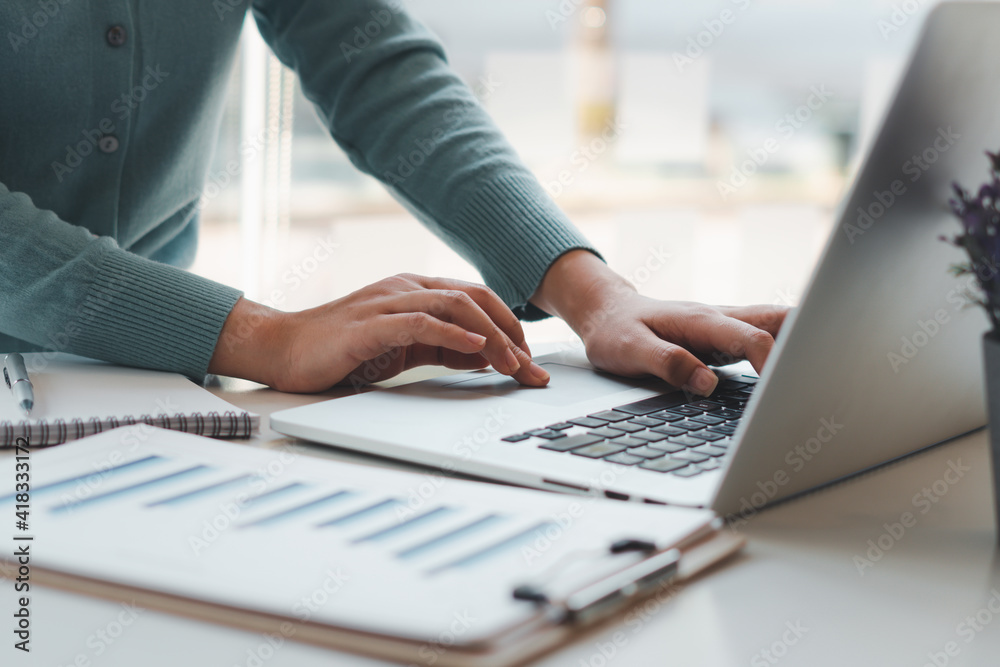 Business woman working and typing on laptop computer on the table. Business woman working and typing on laptop computer on the table.