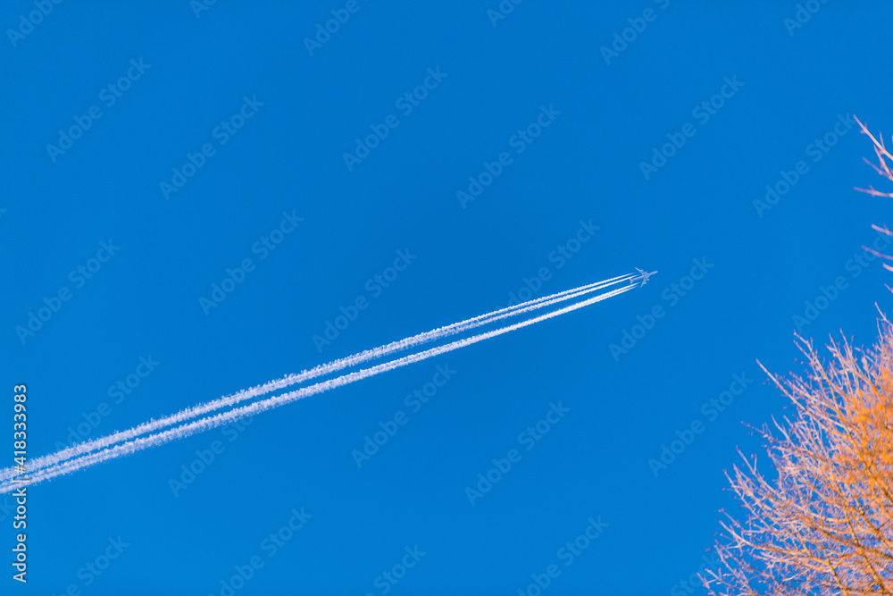 Fototapeta premium airplane with condensation trail