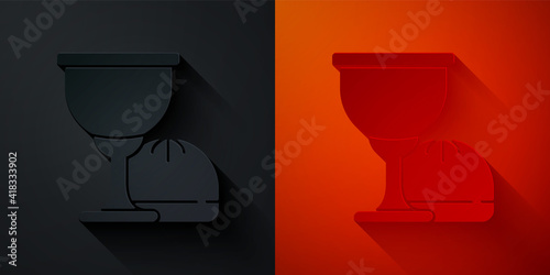 Paper cut Holy grail or chalice icon isolated on black and red background. Christian chalice. Christianity icon. Paper art style. Vector.