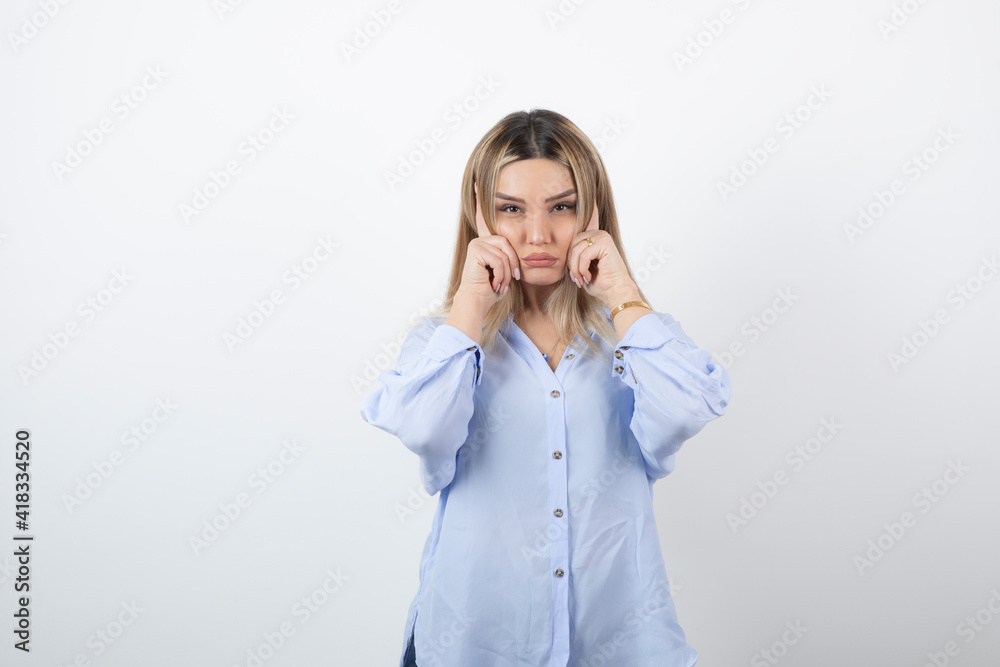 Image of young pretty woman standing on white background Image of young pretty woman standing on white background