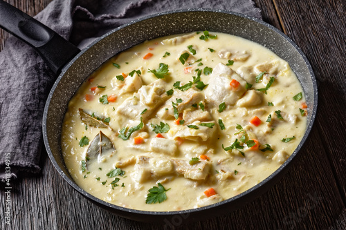 poached cod fish in milk base sauce
