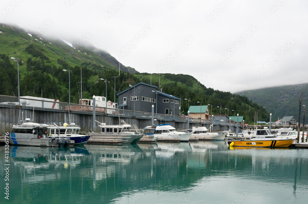 Boats in arctic water high in the misty mountains