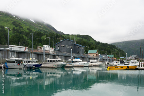 Boats in arctic water high in the misty mountains