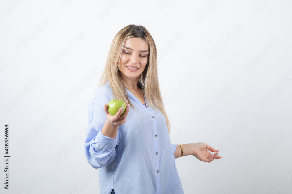 Portrait photo of a pretty attractive woman model standing and holding Portrait photo of a pretty attractive woman model standing and holding