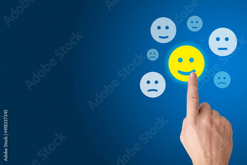 Customer Experience Concept, Best Excellent Services for Satisfaction present by Hand of Client giving happy smiley icon. blue background. copy space