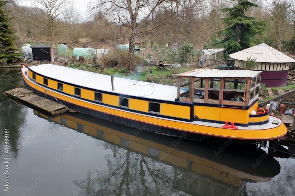 Naklejka premium Yellow narrowboat in the Rickmansworth Canal Basin