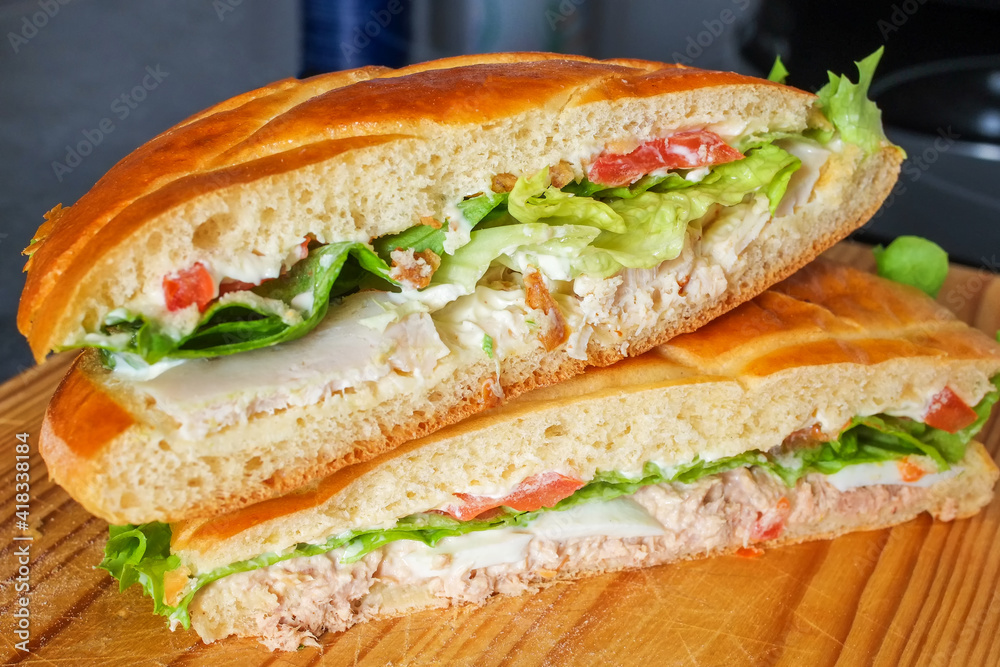 Sandwich with tuna and vegetables on wooden board. Sandwich with tuna and vegetables on wooden board.