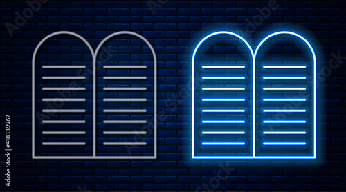 Glowing neon line The commandments icon isolated on brick wall background. Gods law concept. Vector.