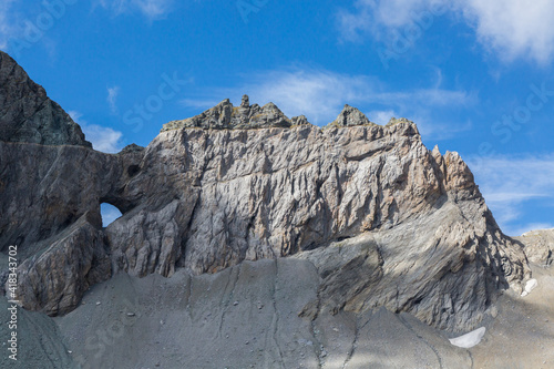 Martinsloch in Swiss tectonic arena Sardona in summer with blue sky photo