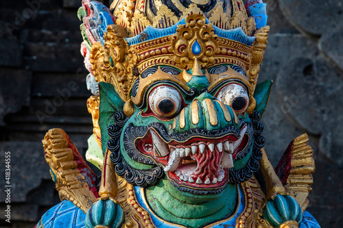 Traditional Balinese demon statue in the street temple. Island Bali, Indonesia