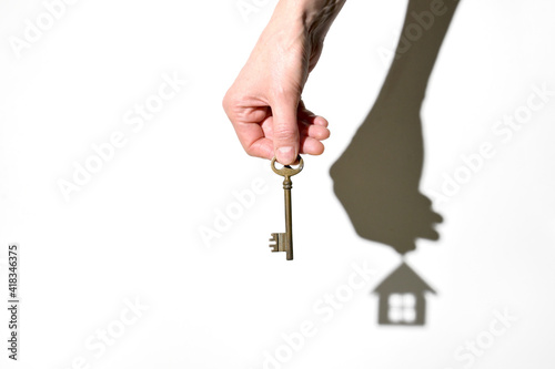 Real Estate Agent With House Key And House Swadow photo