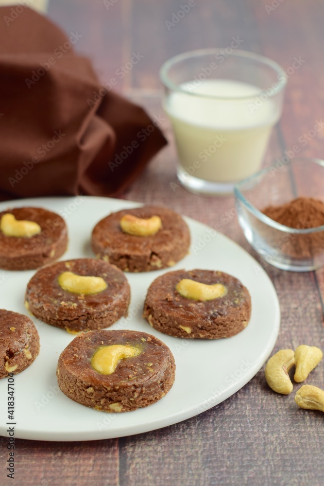 Chocolate cookies with cashew nuts. Served with glass of milk 