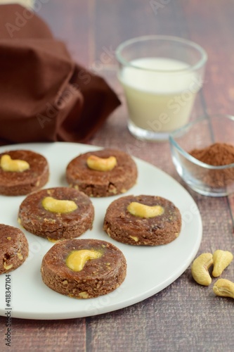 Chocolate cookies with cashew nuts. Served with glass of milk 